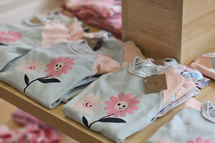 Childrens clothing folded on display shelf Childrens clothing folded on display shelf